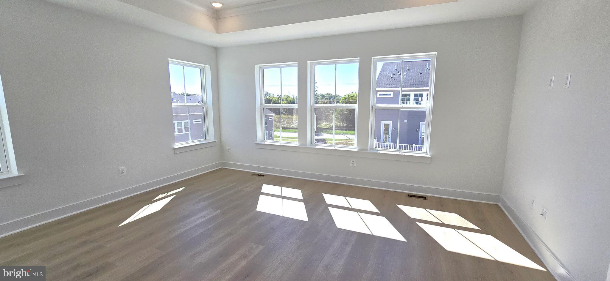 1726 Blacksmith Way Frederick, MD 21702 - Photo 37 of 64 a view of an empty room with wooden floor and a window