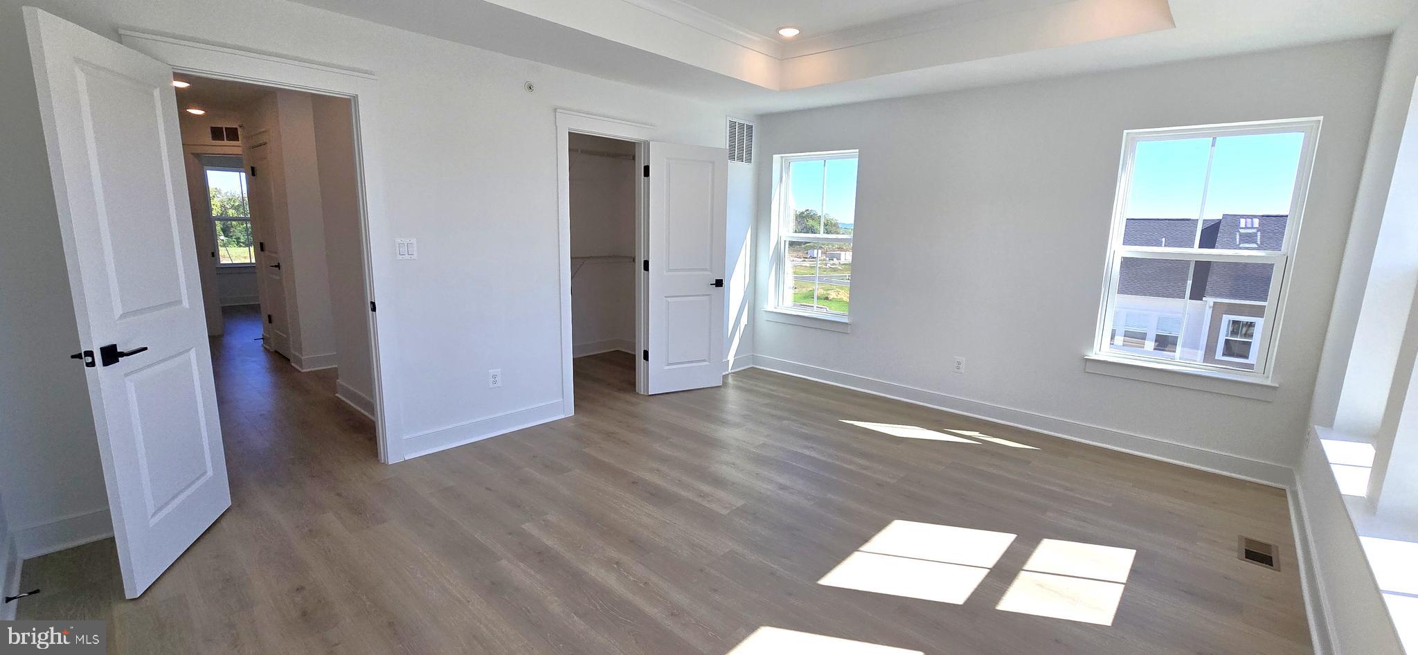 1726 Blacksmith Way Frederick, MD 21702 - Photo 39 of 64 an empty room with wooden floor and windows