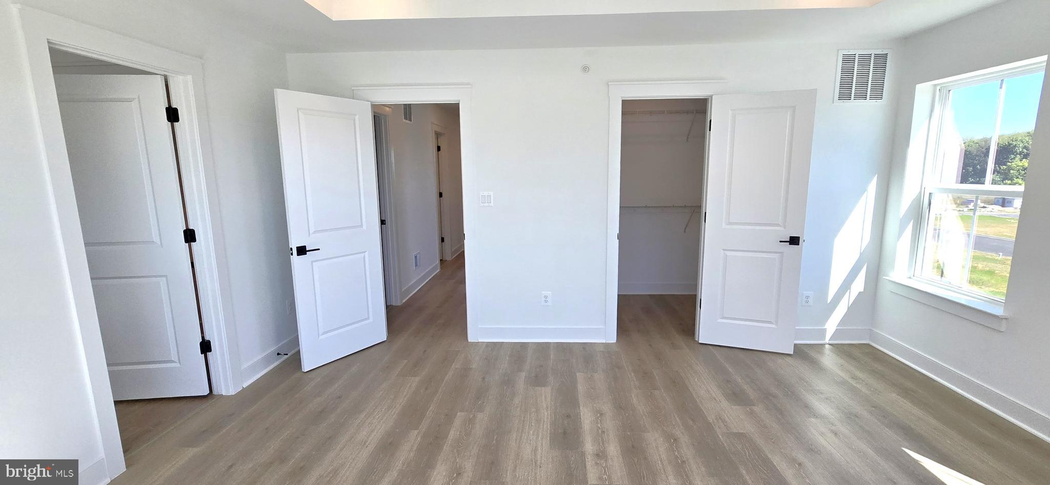 1726 Blacksmith Way Frederick, MD 21702 - Photo 40 of 64 an empty room with wooden floor and windows