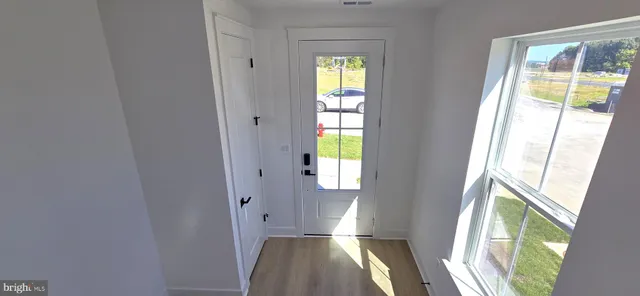 a view of an entryway with wooden floor