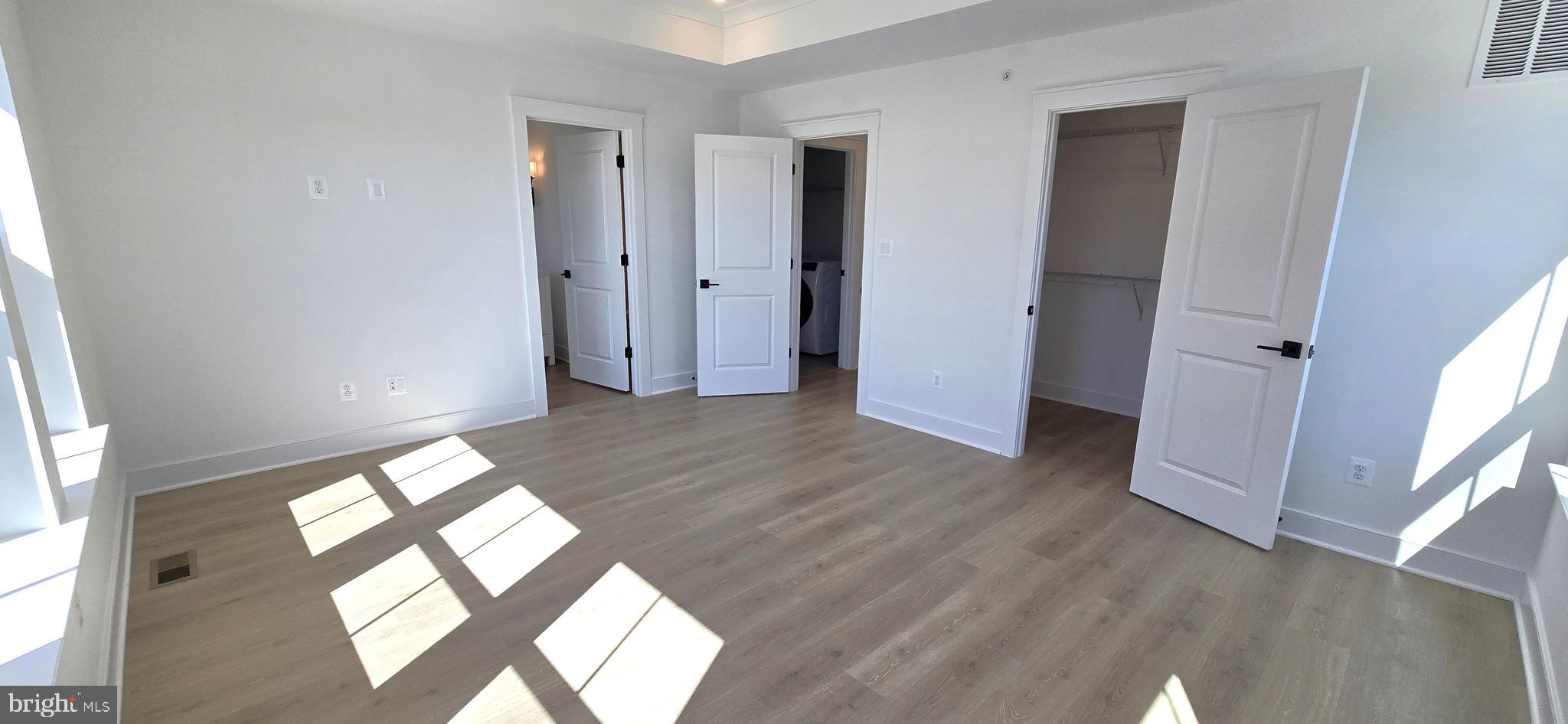 1726 Blacksmith Way Frederick, MD 21702 - Photo 41 of 64 an empty room with wooden floor and windows