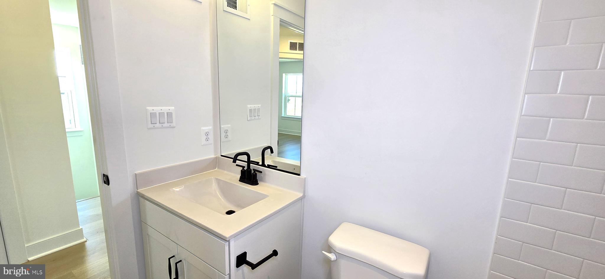 1726 Blacksmith Way Frederick, MD 21702 - Photo 49 of 64 a bathroom with a sink and mirror with toilet