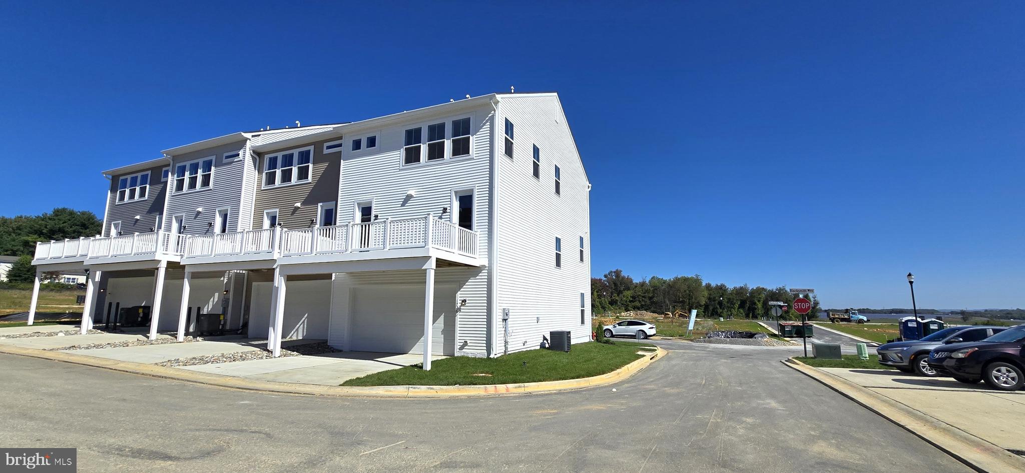 1726 Blacksmith Way Frederick, MD 21702 - Photo 59 of 64 a view of a white house with a yard and parking space