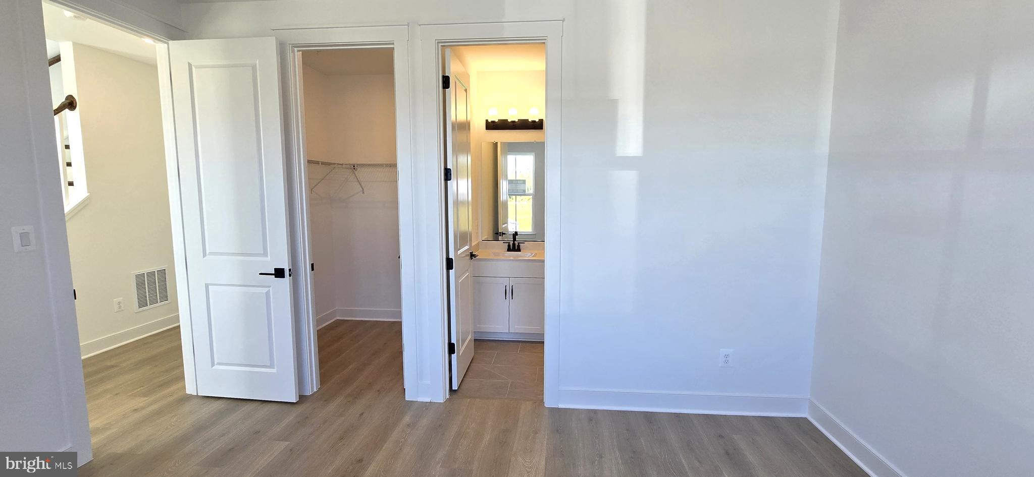 1726 Blacksmith Way Frederick, MD 21702 - Photo 6 of 64 a view of a hallway with wooden floor and closet area