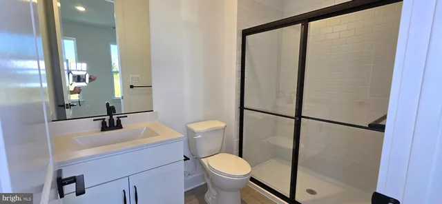 a kitchen with stainless steel appliances kitchen island granite countertop a refrigerator and a stove top oven