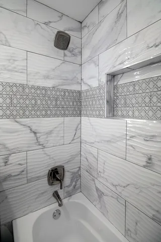 a bathroom with a bathtub and shower