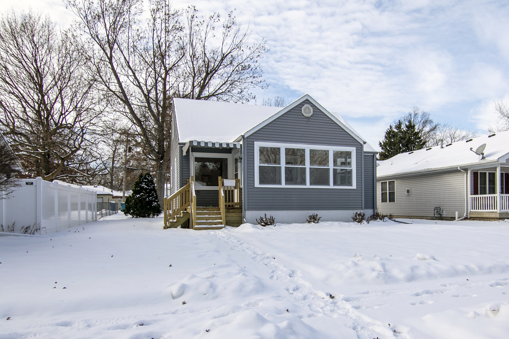 635 South Alma Avenue Kankakee, IL 60901 - Photo 4 of 21 a view of a house with a yard covered in snow