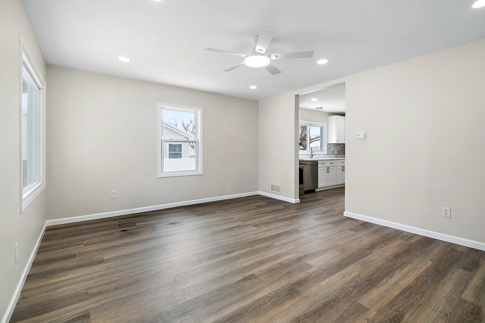 635 South Alma Avenue Kankakee, IL 60901 - Photo 6 of 21 an empty room with wooden floor chandelier and windows