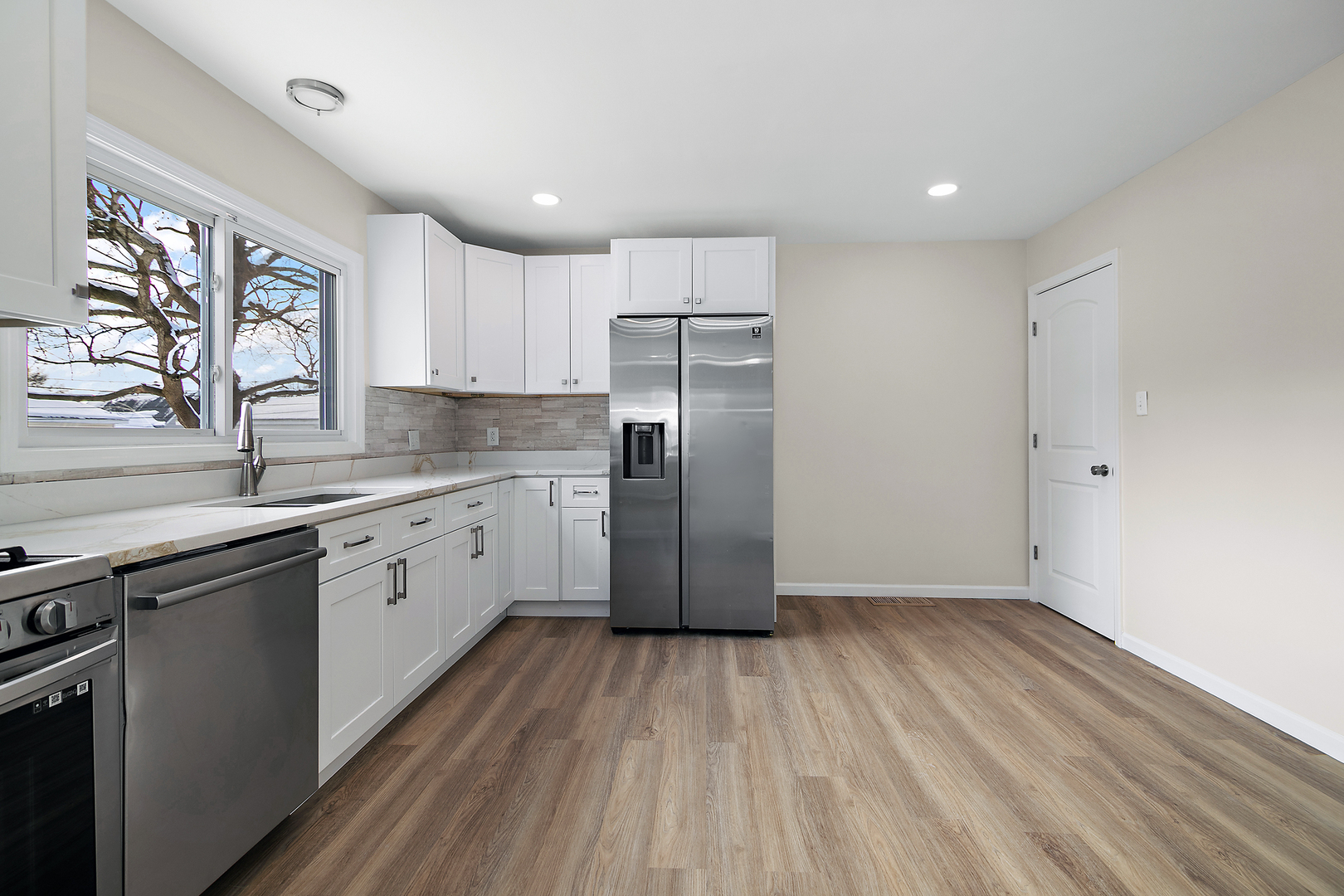 635 South Alma Avenue Kankakee, IL 60901 - Photo 8 of 21 a kitchen with a sink wooden floor and stainless steel appliances