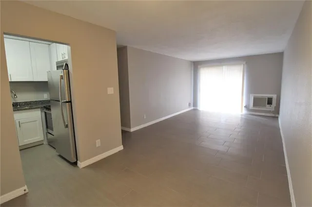 a view of a kitchen with a sink and refrigerator