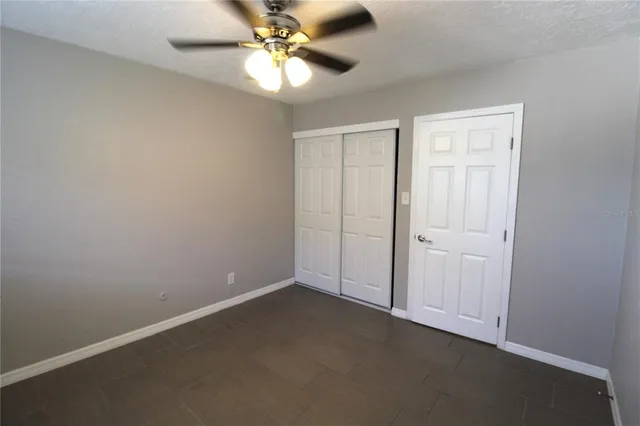 an empty room with a fan and a fan