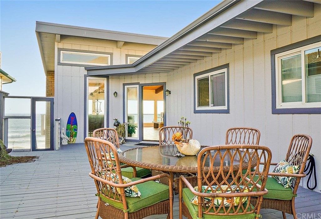 a view of a dining room with furniture a chandelier and wooden floor