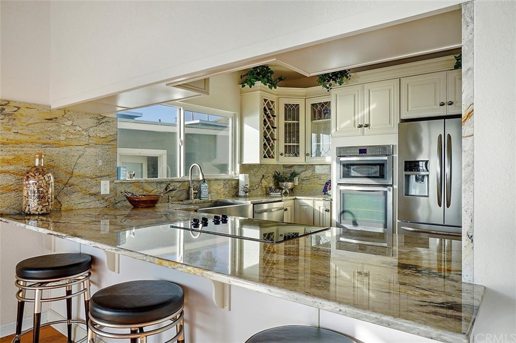 3498 Studio Drive Cayucos, CA 93430 - Photo 14 of 36 a kitchen with a sink appliances and cabinets
