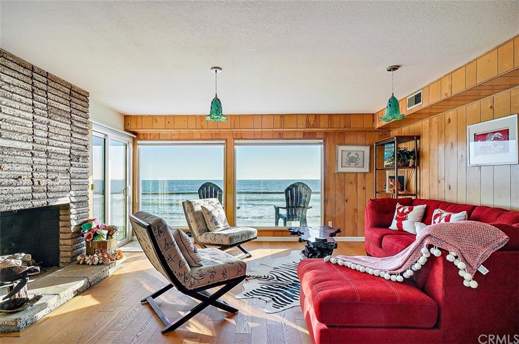 3498 Studio Drive Cayucos, CA 93430 - Photo 27 of 36 a living room with furniture a fireplace and a floor to ceiling window