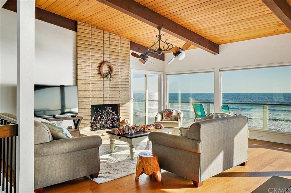 3498 Studio Drive Cayucos, CA 93430 - Photo 7 of 36 a living room with furniture a fireplace and a table