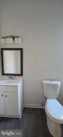 a bathroom with a toilet a sink and a mirror