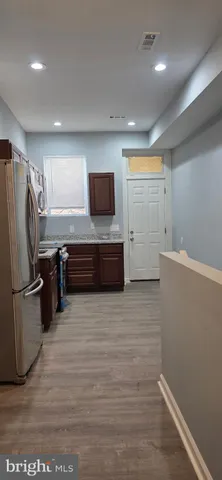 a kitchen with stainless steel appliances a refrigerator and a microwave