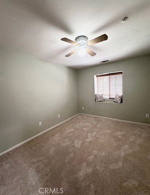 8692 East 9th Street, Unit 56 Rancho Cucamonga, CA 91730 - Photo 17 of 34 an empty room with windows and fan