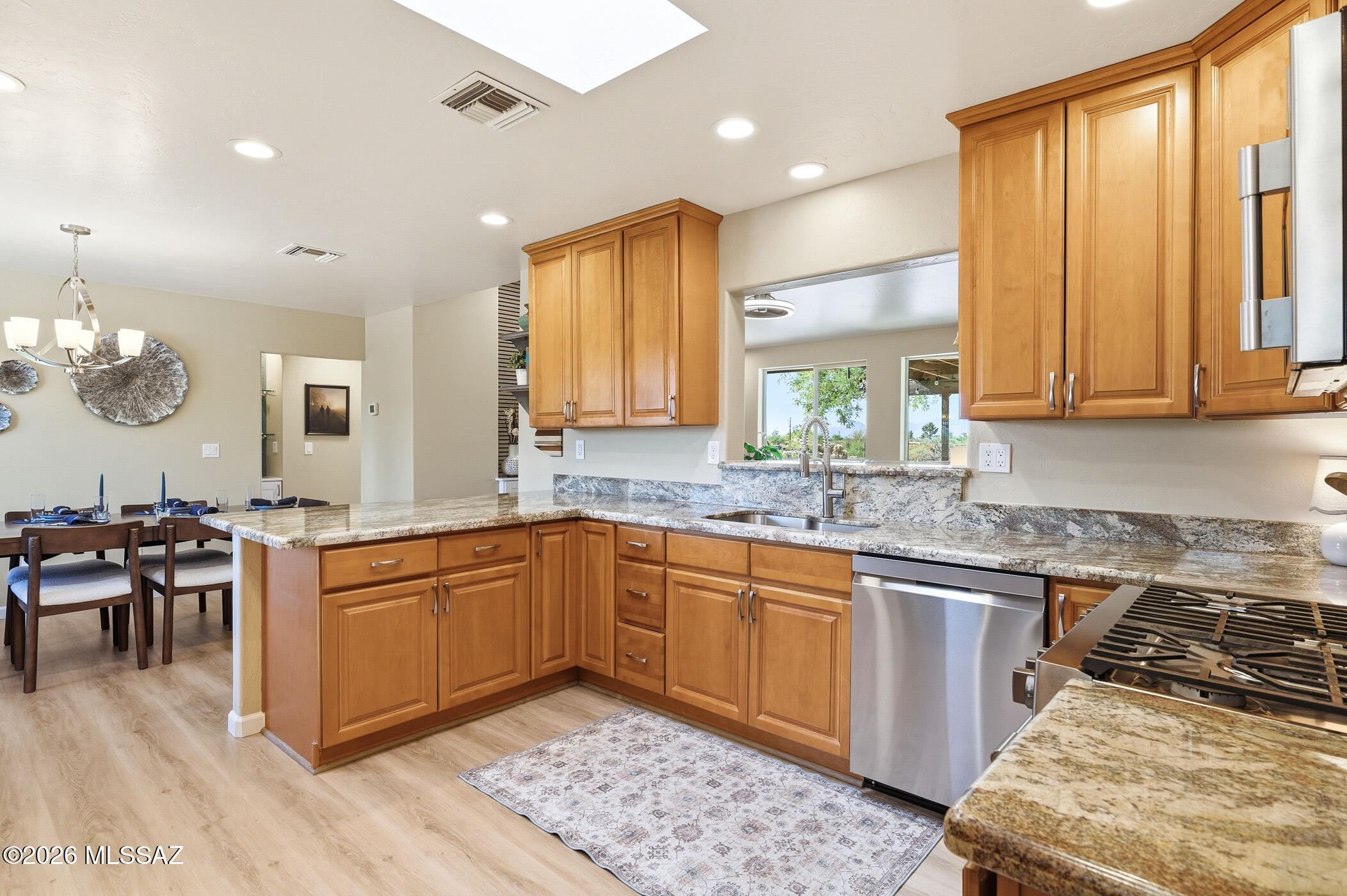 13599 East Rincon Ranch Road Vail, AZ 85641 - Photo 13 of 41 a kitchen with stainless steel appliances granite countertop wooden cabinets a sink and a stove