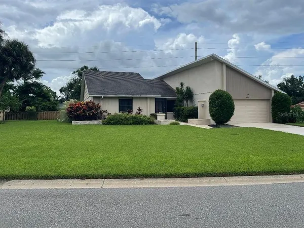 a view of house with backyard