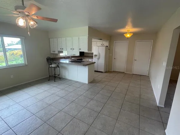 a kitchen with stainless steel appliances a sink cabinets and a refrigerator