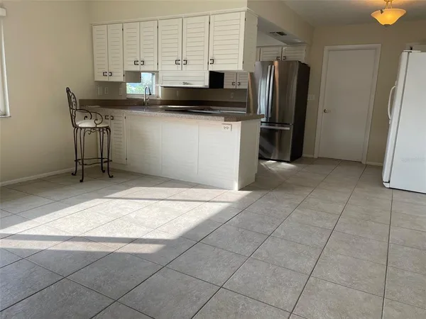 a kitchen with stainless steel appliances granite countertop a refrigerator and a sink