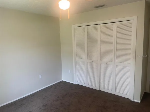 a living room with a floor to ceiling window and a floor to ceiling window