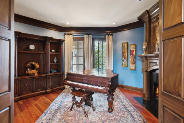 a kitchen that has a lot of white cabinets and stainless steel appliances