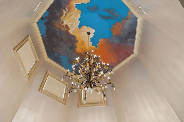 a living room with patio furniture and a flat screen tv