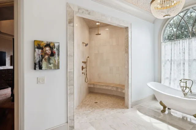 a dining room with furniture a chandelier and wooden floor