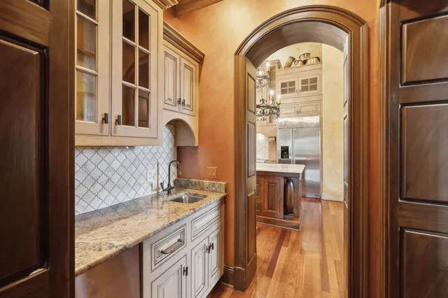 a bedroom with a large bed and a chandelier