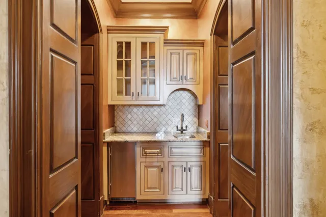 a bedroom with a bed chandelier and a window