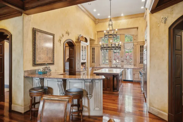 a bathroom with a granite countertop sink mirror vanity and toilet
