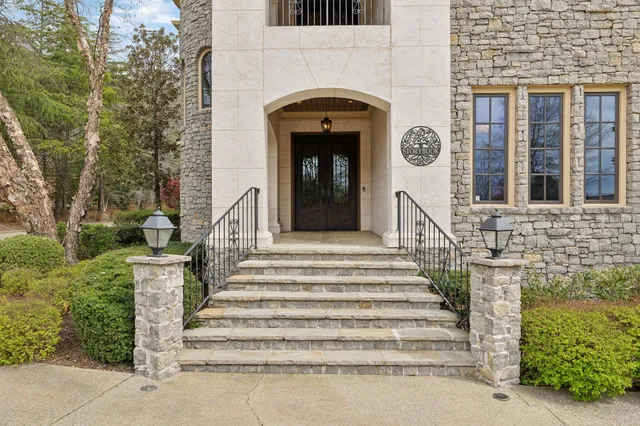a living room with fireplace furniture and a rug