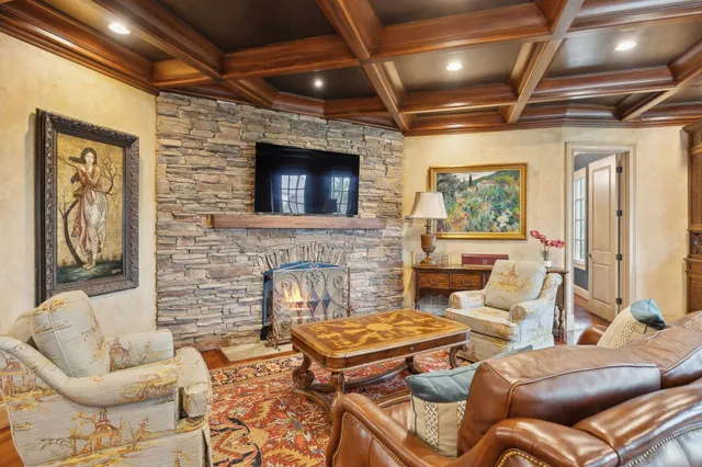 a spacious bedroom with a bed and a chandelier