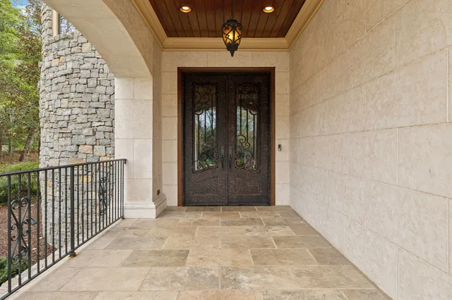 a living room with couches chairs and a chandelier