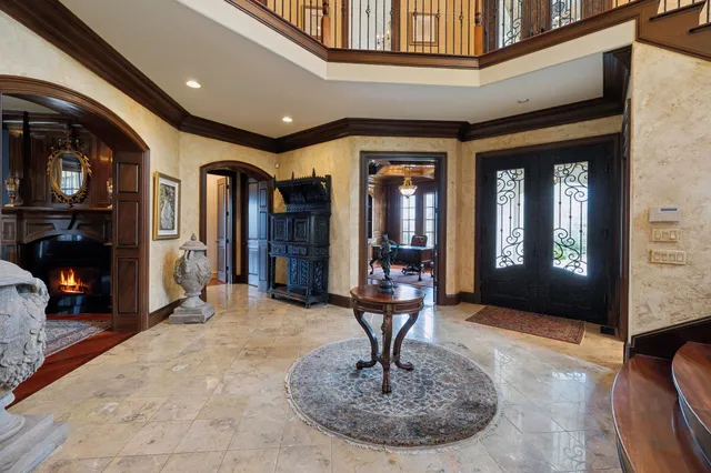 a living room with a bed and a dresser next to a window