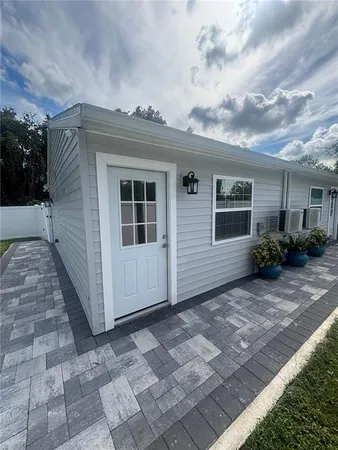 a view of a house with a backyard