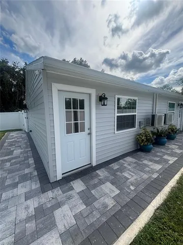 a view of a house with a backyard
