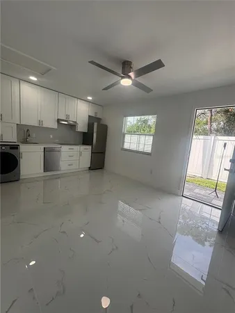 a view of kitchen with windows and ceiling fan