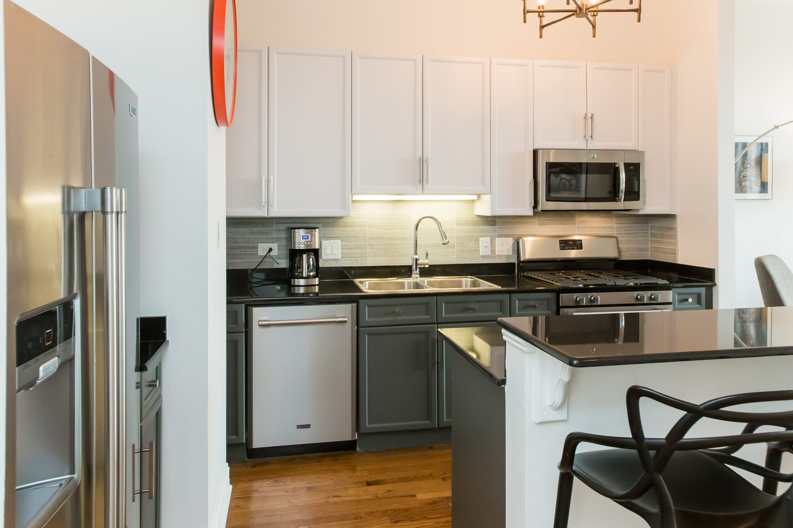 1201 West Adams Street, Unit 705 Chicago, IL 60607 - Photo 12 of 30 a kitchen with stainless steel appliances granite countertop a stove a sink and a refrigerator