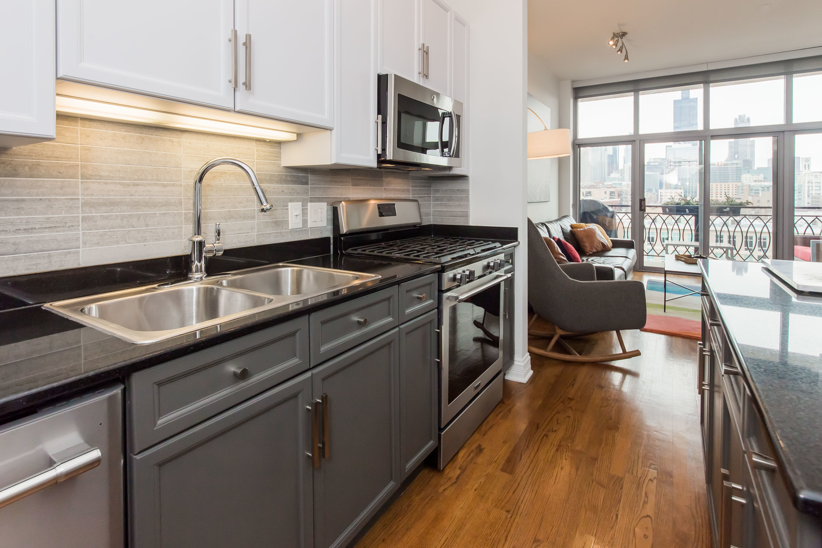 1201 West Adams Street, Unit 705 Chicago, IL 60607 - Photo 13 of 30 a kitchen with stainless steel appliances granite countertop a sink stove and cabinets