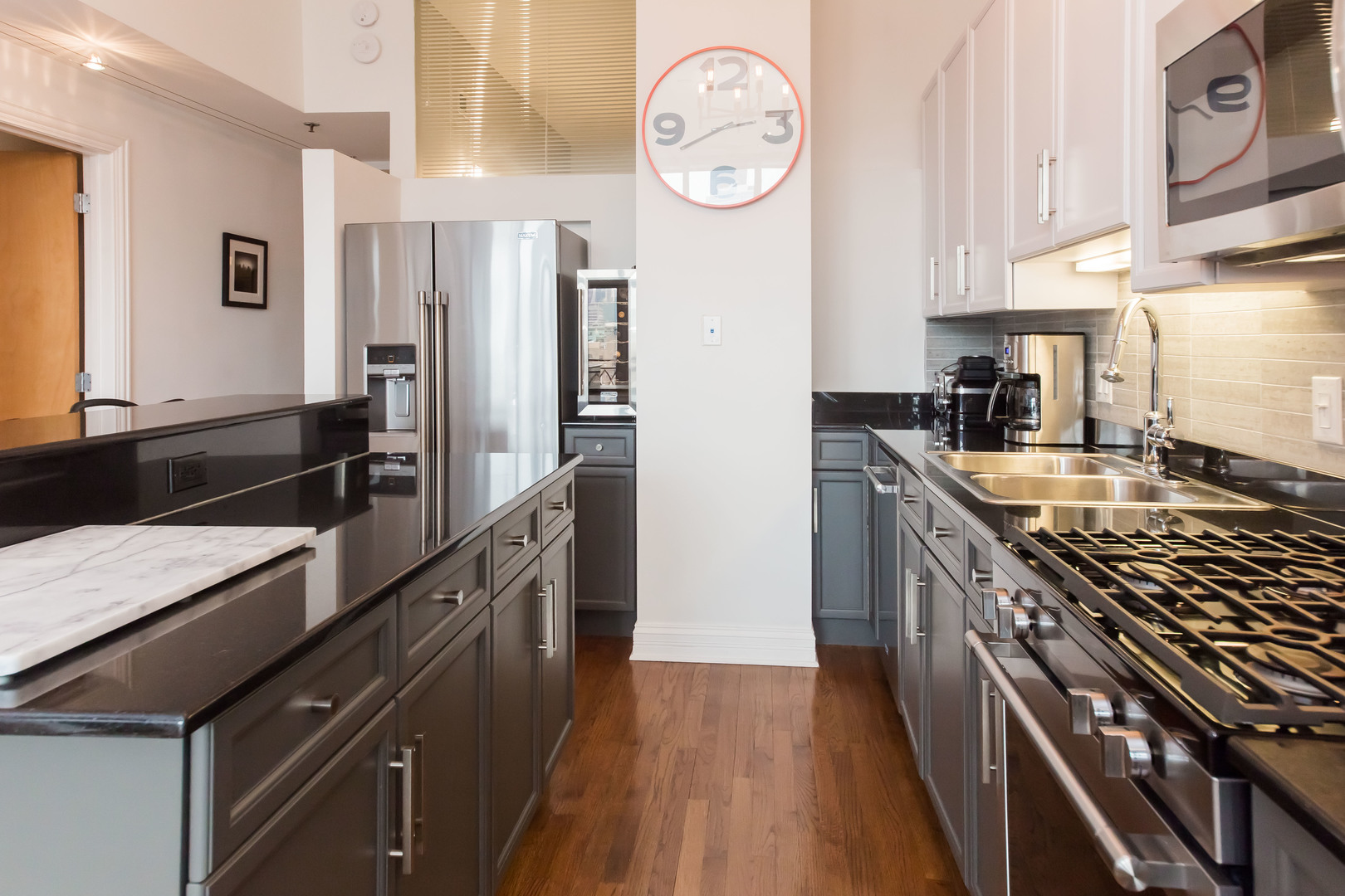 1201 West Adams Street, Unit 705 Chicago, IL 60607 - Photo 14 of 30 a kitchen with stainless steel appliances granite countertop a stove and a refrigerator