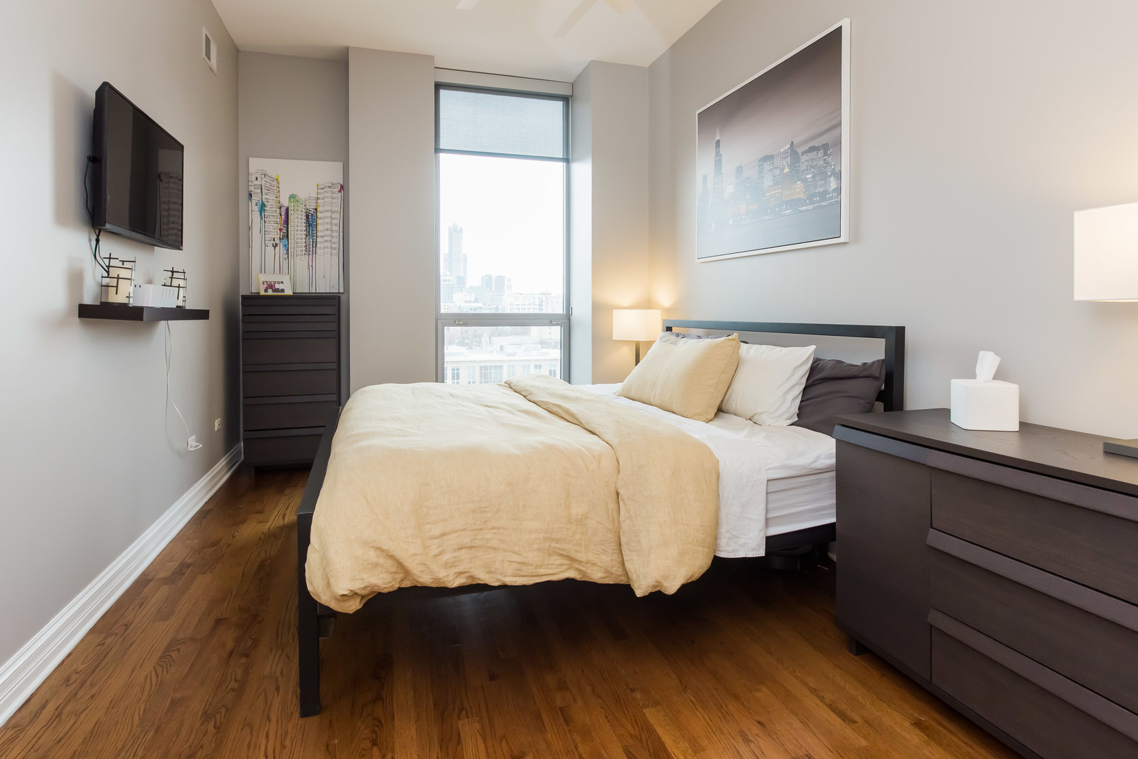 1201 West Adams Street, Unit 705 Chicago, IL 60607 - Photo 15 of 30 a bedroom with a bed and wooden floor