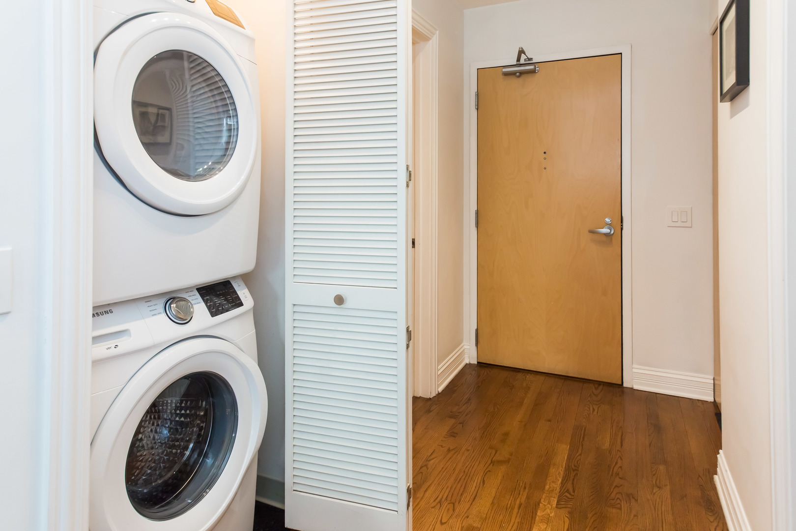 1201 West Adams Street, Unit 705 Chicago, IL 60607 - Photo 23 of 30 a view of a hallway with washer and dryer