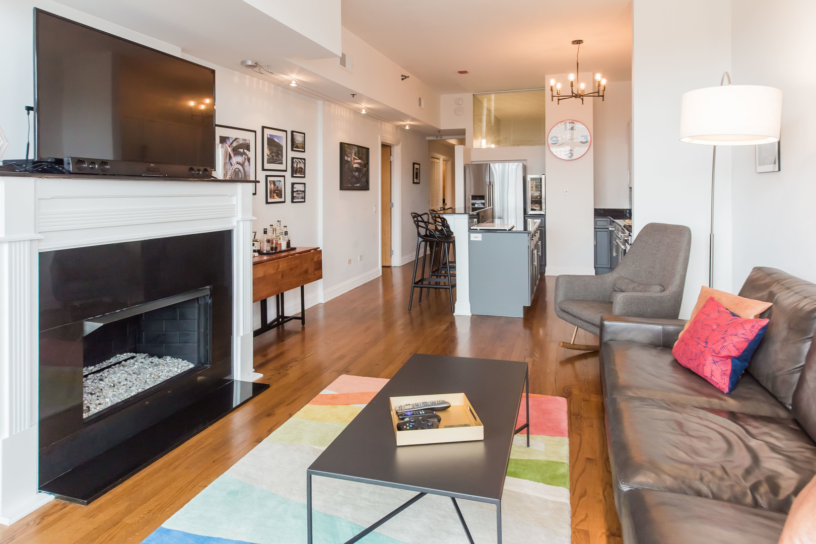 1201 West Adams Street, Unit 705 Chicago, IL 60607 - Photo 7 of 30 a living room with furniture fireplace and flat screen tv