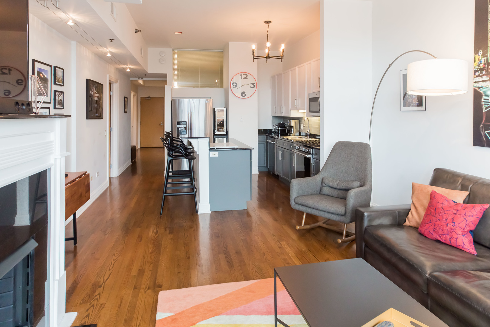 1201 West Adams Street, Unit 705 Chicago, IL 60607 - Photo 8 of 30 a living room with furniture kitchen view and a wooden floor