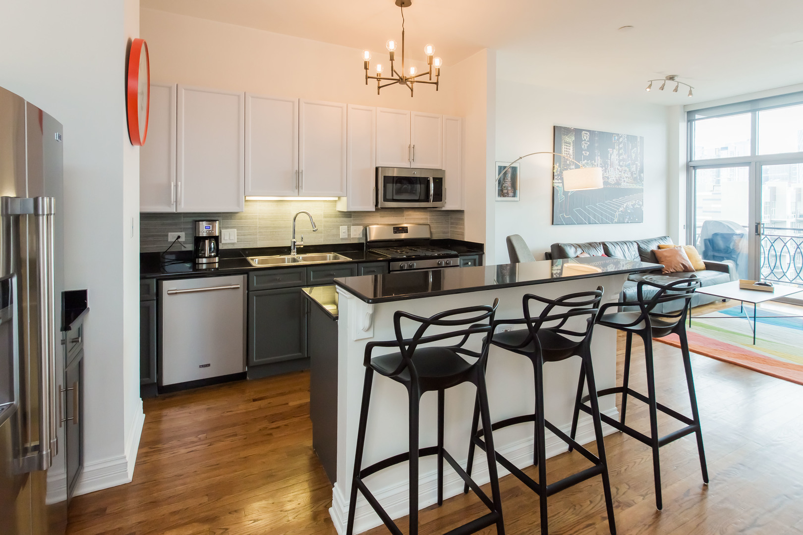 1201 West Adams Street, Unit 705 Chicago, IL 60607 - Photo 10 of 30 a kitchen with stainless steel appliances a table chairs sink and cabinets