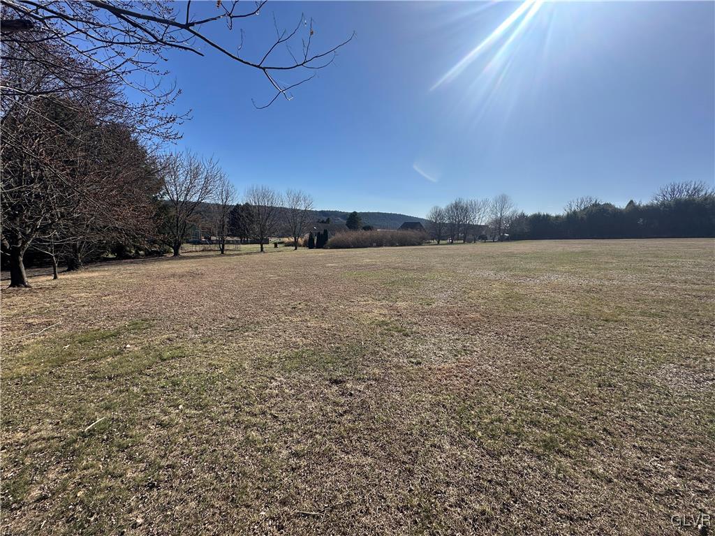 a view of an ocean beach and mountain