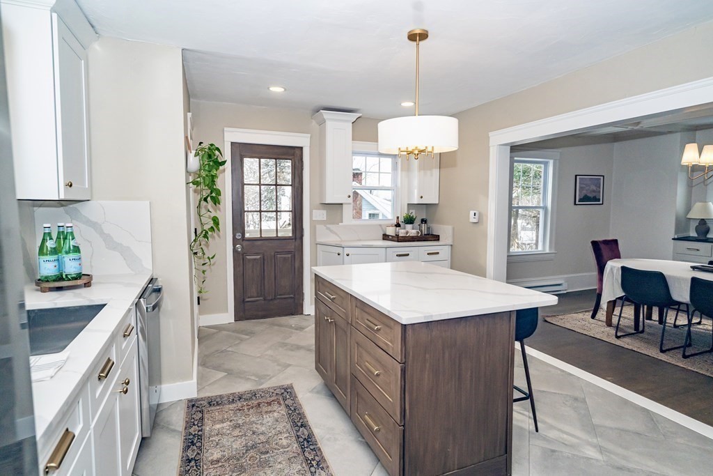 65 Hadwen Road Worcester, MA 01602 - Photo 15 of 38 a kitchen with a sink stove and cabinets